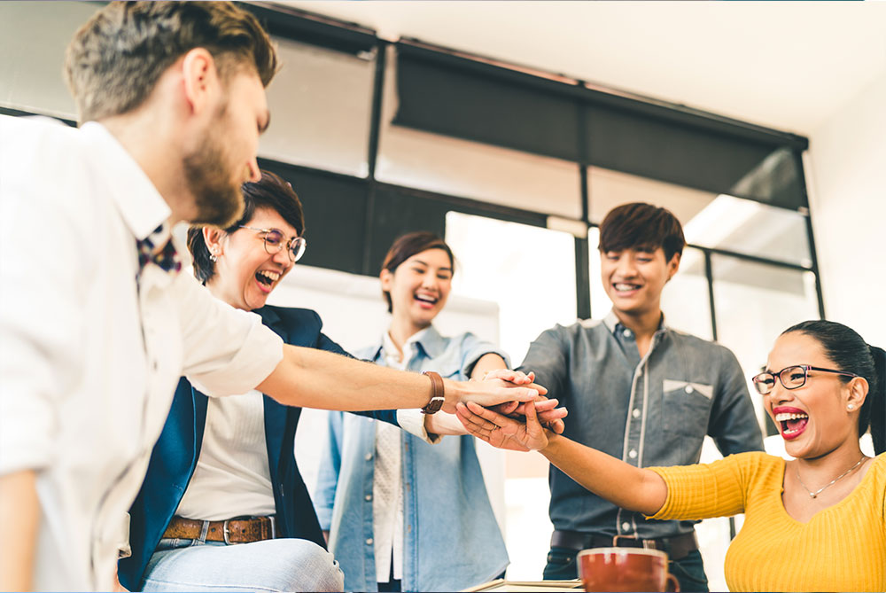 image of team members putting hands together